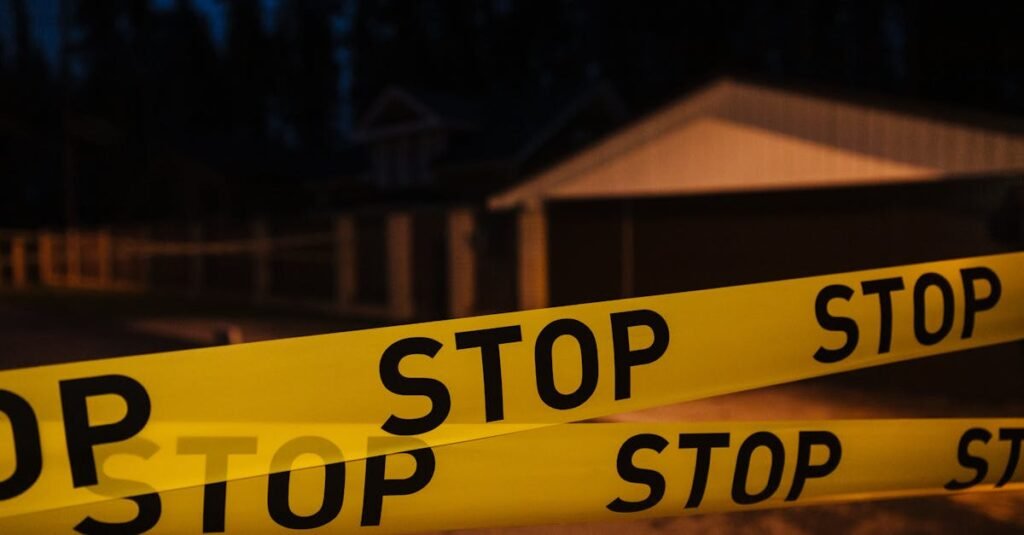 Arizona Police Helicopter Crash: Yellow stop tape blocking a residential street at night, creating a restricted area.