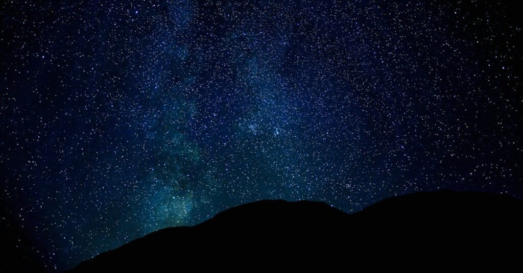 pexels-photo-11816821-11816821 A stunning view of the star-filled night sky with silhouetted mountains beneath, offering a serene and captivating scene.