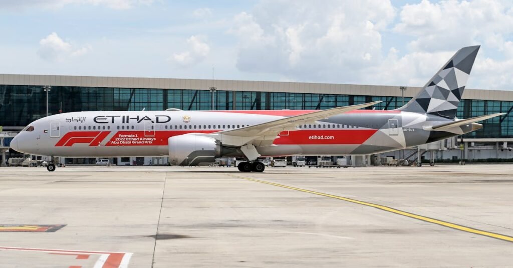 Etihad Airways Boeing 787 with Formula 1 livery parked at a modern airport.