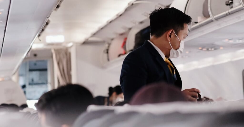 pexels-photo-12692959-12692959 A flight attendant wearing a mask assists passengers on a commercial Alaska Airlines flight.