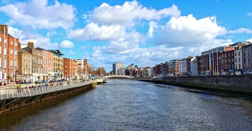 pexels-photo-16211558-16211558 Beautiful daytime view of the River Liffey flowing through Dublin, Ireland, with iconic city buildings.