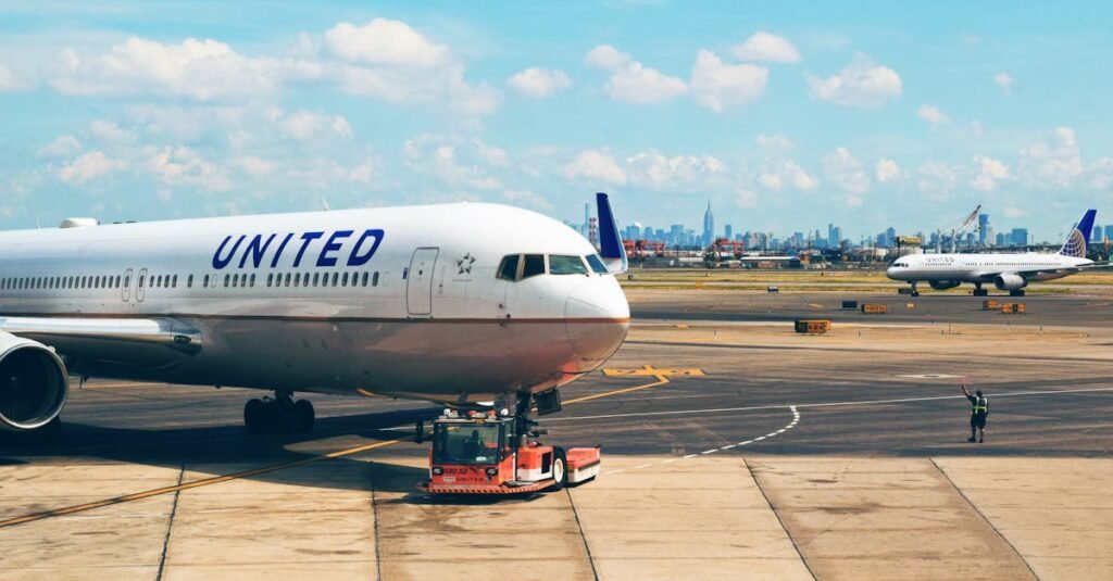 United Airlines Aircraft on the runway at Newark Airport with city skyline in the background.