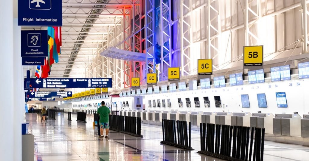 Wide view of Chicago airport terminal showcasing architecture and check-in counters. Flags and signages add vibrant detail.