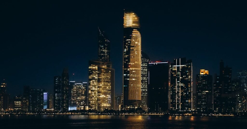 Stunning night view of Abu Dhabi's illuminated skyline reflecting on the water.
