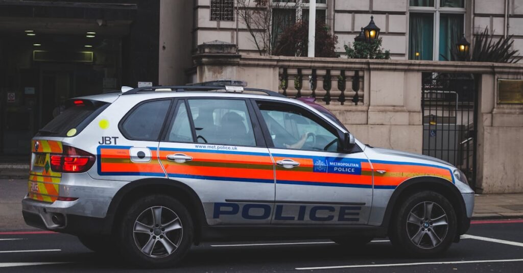 pexels-photo-303313-303313 Police vehicle parked on an urban street outside a London building