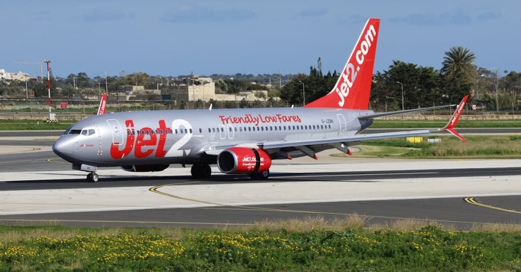 pexels-photo-30773889-30773889 Jet2 airplane on airport tarmac with clear blue sky, showcasing travel and transportation.
