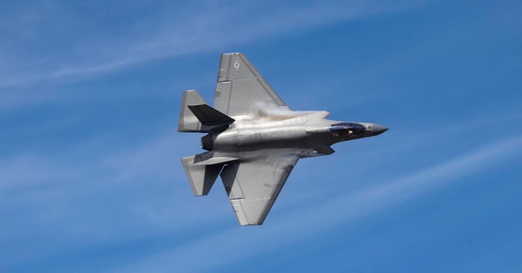 US F-35 Pilot Arrest - Lightning II jet soaring above Kernville, CA against a clear blue sky, showcasing its sleek design.