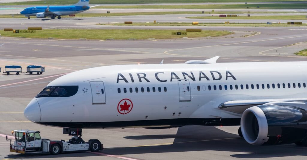 Air Canada Boeing 787 Dreamliner on the airport tarmac during a sunny day.