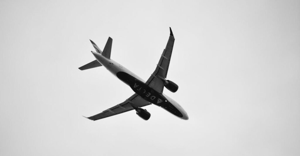 Black and white image of a commercial airplane flying overhead, showcasing aviation in San Antonio, Texas.