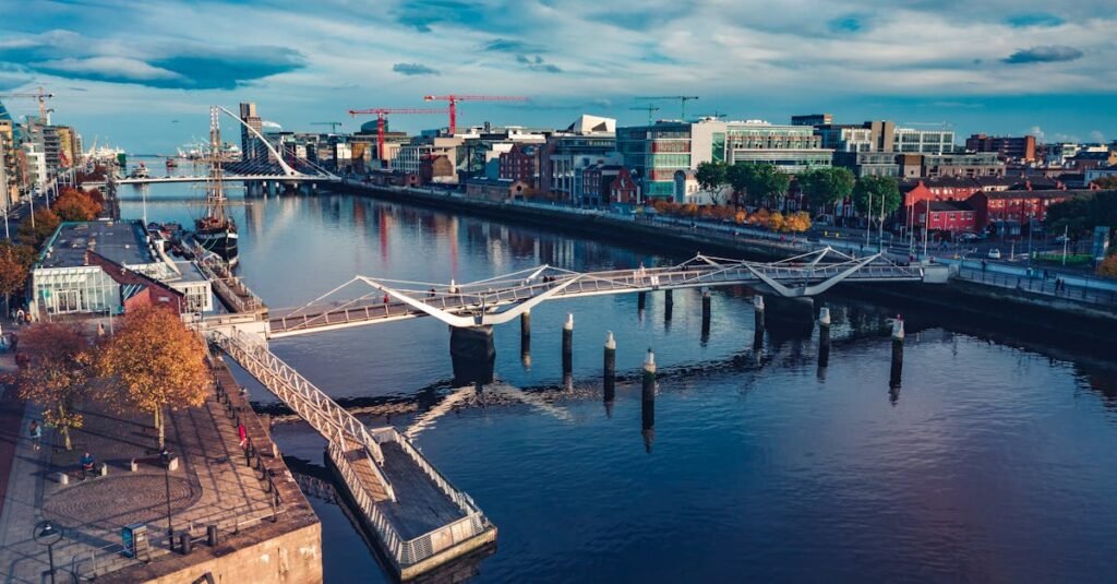 pexels-photo-3566187-3566187 Stunning aerial view of Dublin cityscape featuring the river, modern architecture, and bridges.