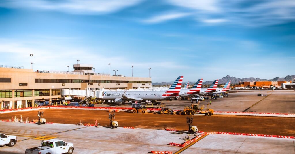 Line of American Airlines planes at Phoenix Sky Harbor with mountains in background.