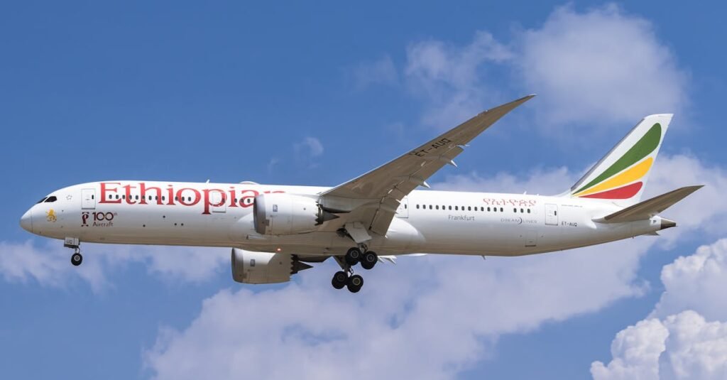 pexels-photo-11136993-11136993 Side view of Ethiopian Airlines Boeing 787 flying against a blue sky with clouds.