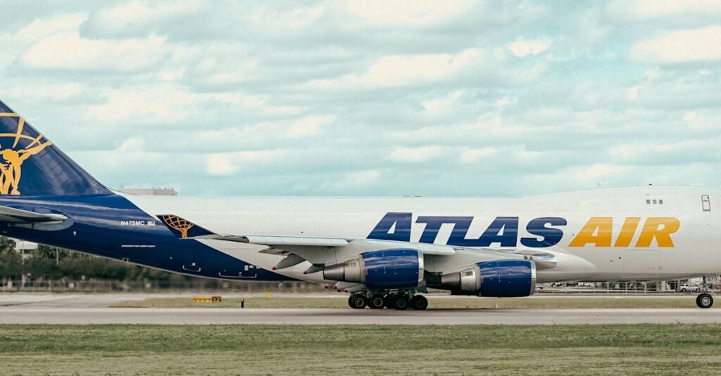 Side view of an Atlas Air cargo airplane taxiing on the runway at an airport.