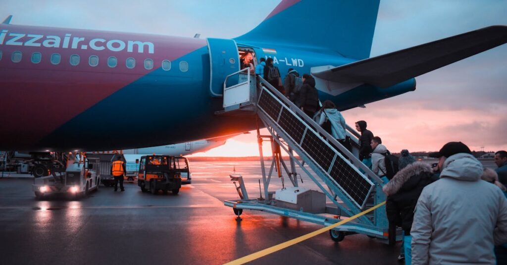 Hijack Embry-Riddle Plane - Passengers boarding an airplane at sunset with a vivid sky in the background, capturing a travel moment.