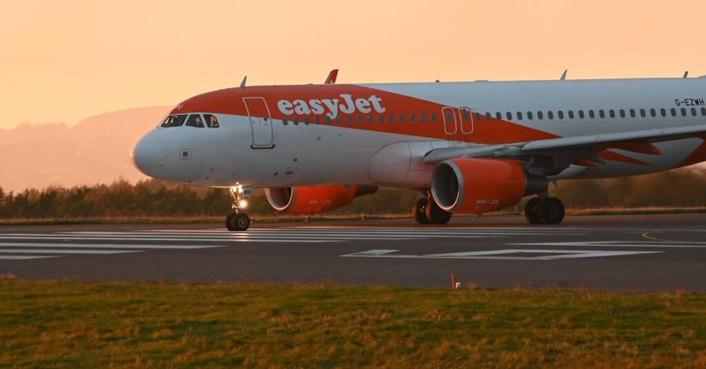 EasyJet airplane taxiing on the runway during a vibrant sunset.
