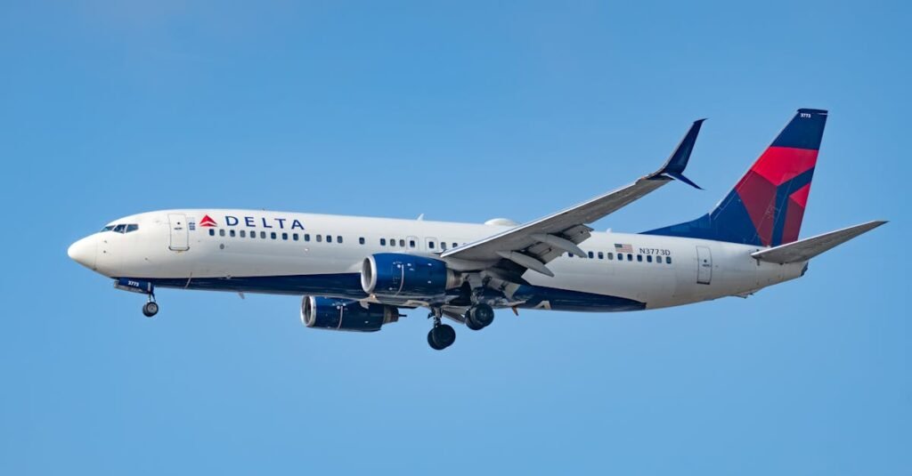 A Delta Air Lines Boeing 737 captured in flight against a clear blue sky near Los Angeles.