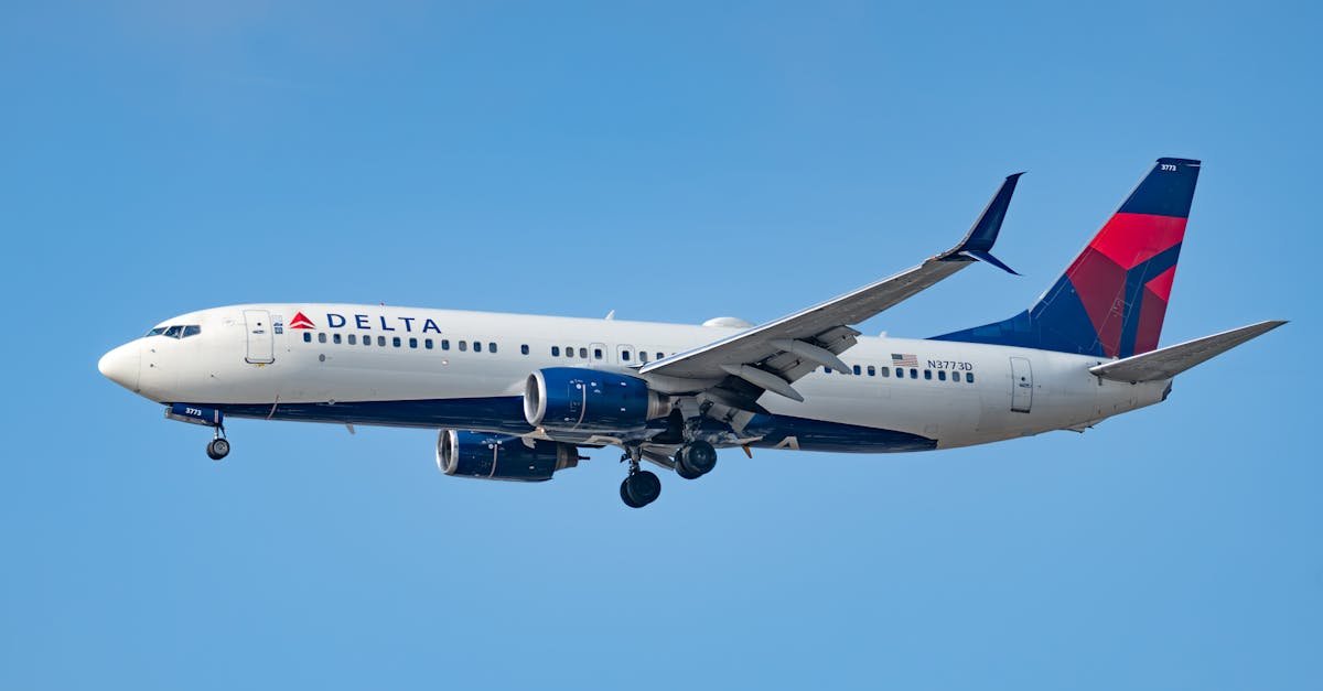 A Delta Air Lines Boeing 737 captured in flight against a clear blue sky near Los Angeles.