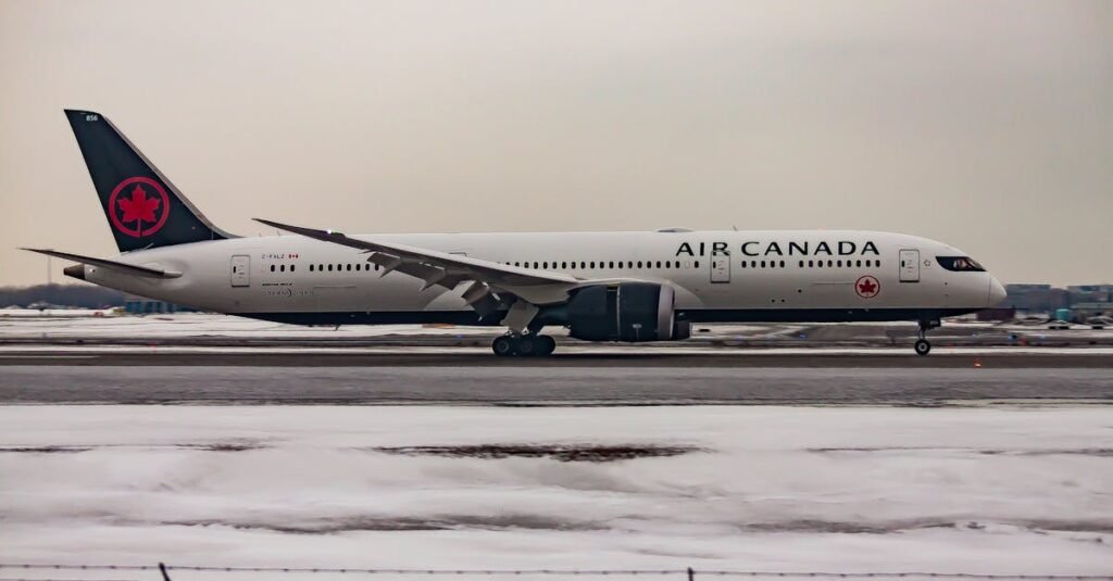 Air Canada jet taking off from a snowy runway, showcasing modern aviation travel in winter.
