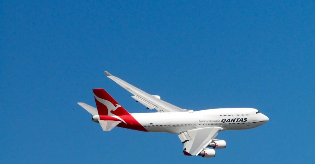 Qantas Boeing 747 captured mid-flight against a clear blue sky, symbolizing aviation and travel.