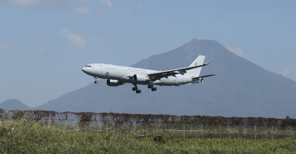 Air France a330-commercial airplane taking off with a stunning volcano backdrop in Manado, Indonesia.