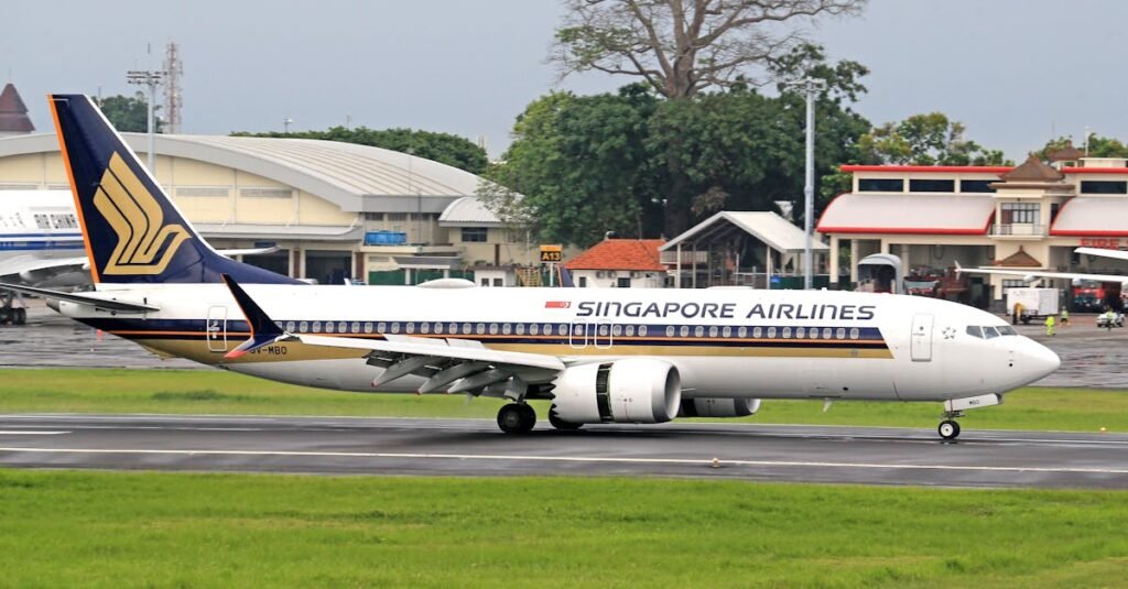 Singapore Airlines passenger jet taxiing on runway, ready for takeoff.
