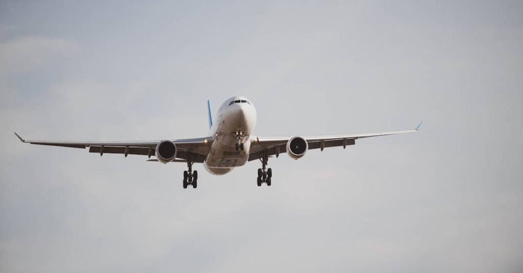 Large commercial Frontier airplane flying through a cloudy sky, captured from below mid-flight.